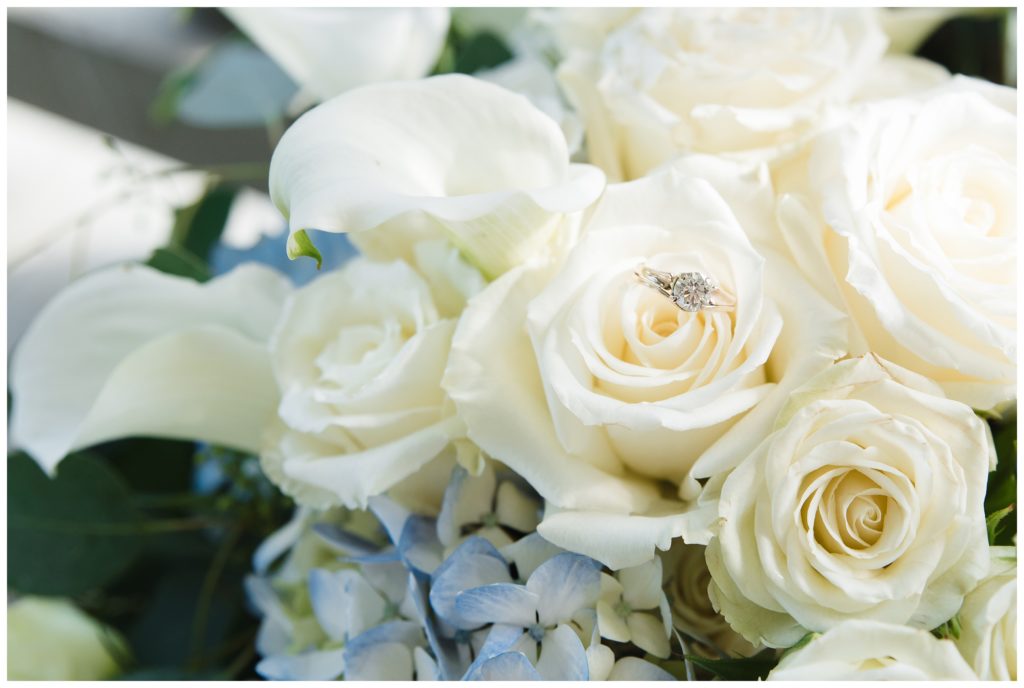 bride's ring in white rose bouquet at the farm house inn
