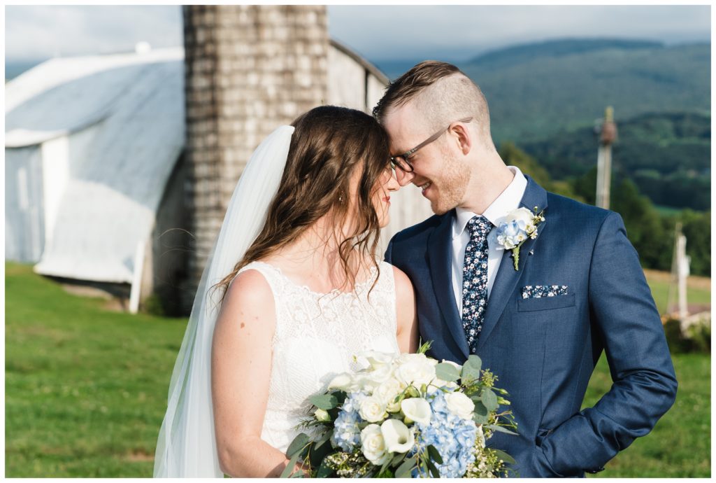 bride and groom leaning foreheads together at the farm house inn