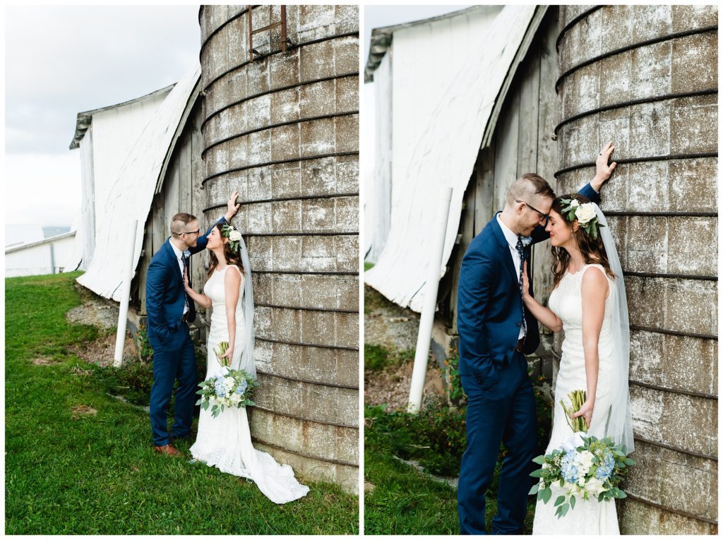 bride and groom leaning against silo at the farm house inn