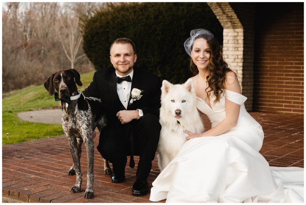 bride and groom with dogs by arches at laube hall, freeport, pa