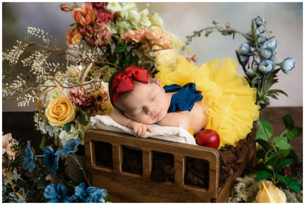 newborn girl in snow white outfit at bridgeville newborn photographer studio