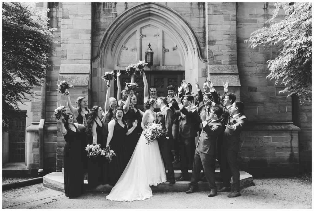 bride and groom kiss outside harbison chapel in black and white