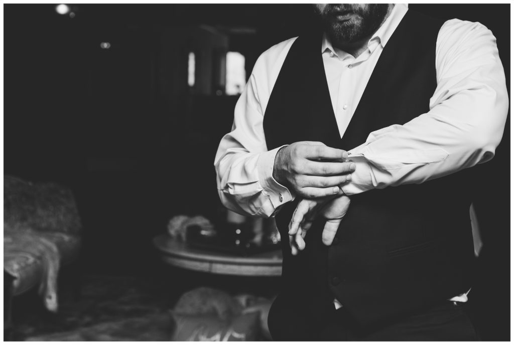black and white images of groom putting on cufflinks at lakeview golf resort 