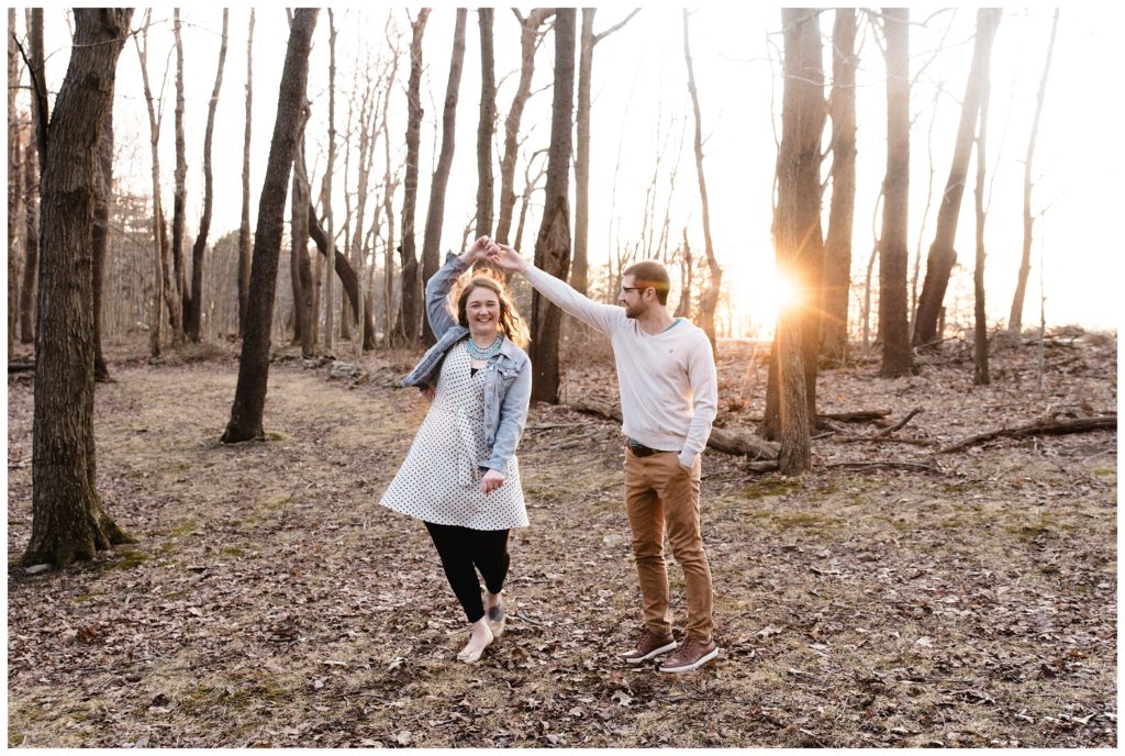 couple dancing at sunset in woods