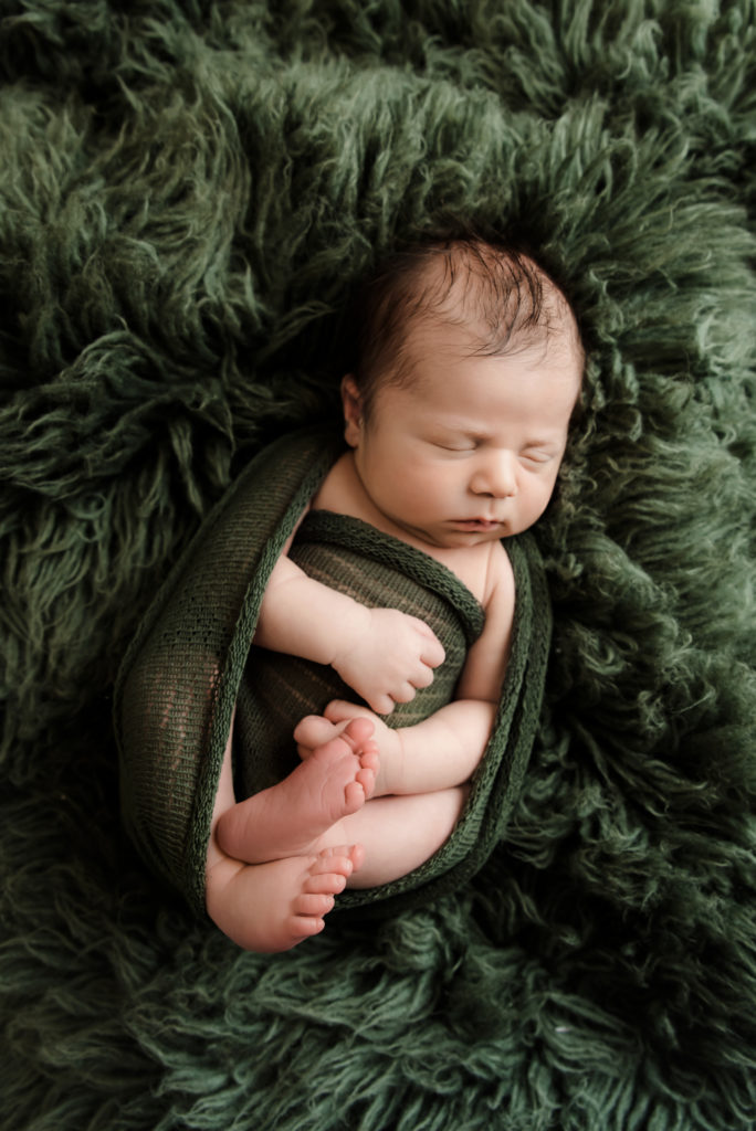 Baby boy in green wrap showing little hands and toes | Pittsburgh Newborn Photographer