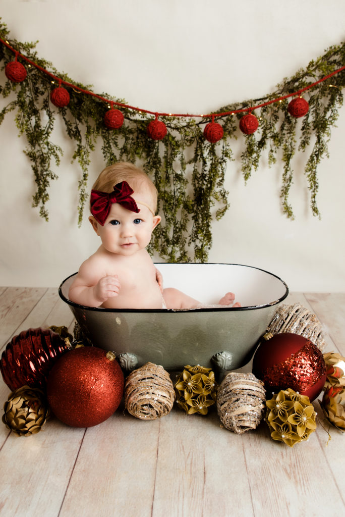 baby girl in tub decorated for christmas