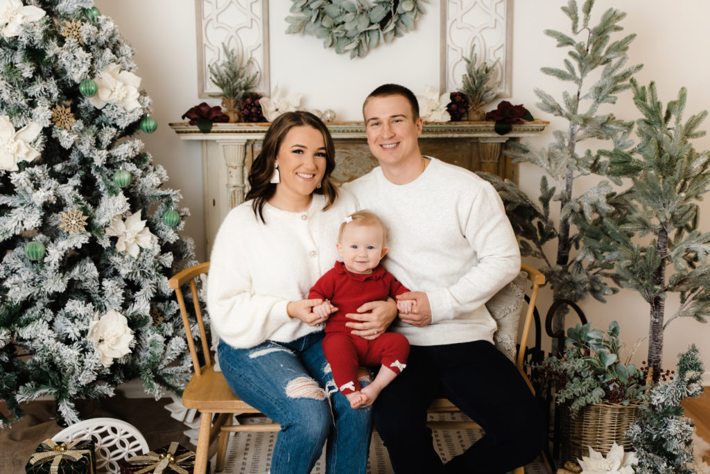 family posing in front of studio christmas scene | Pittsburgh Family Photographer