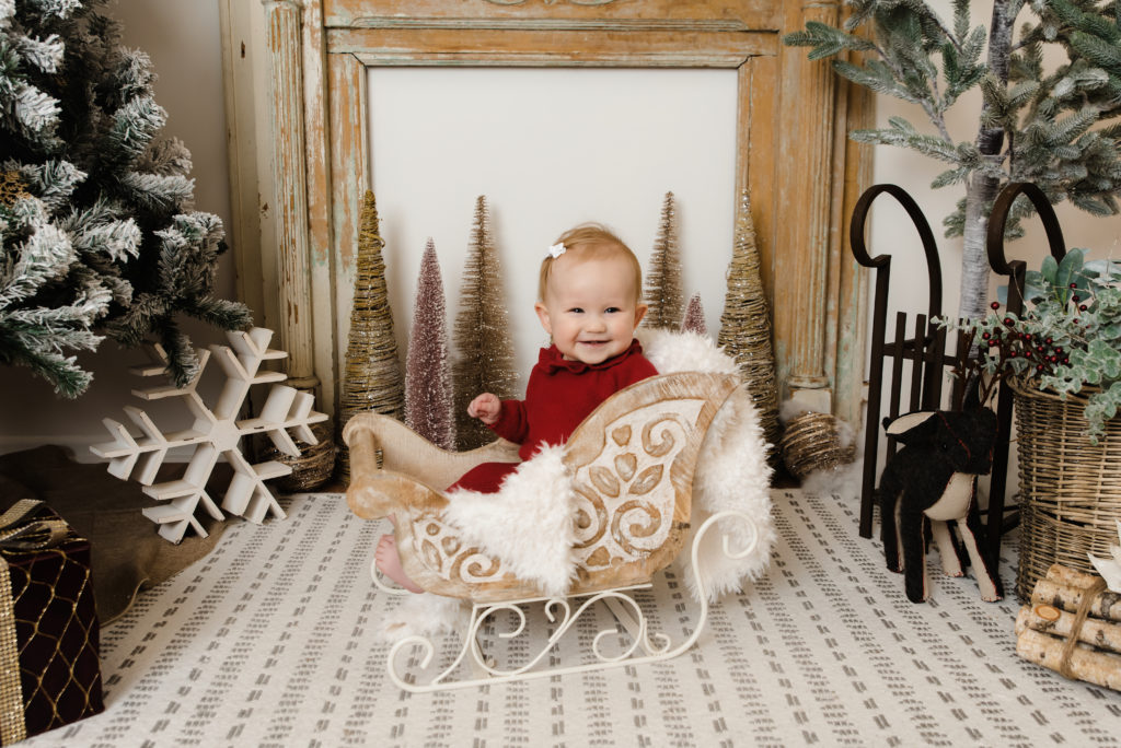 baby girl smiling in sleigh prop | Pittsburgh Family Photographer