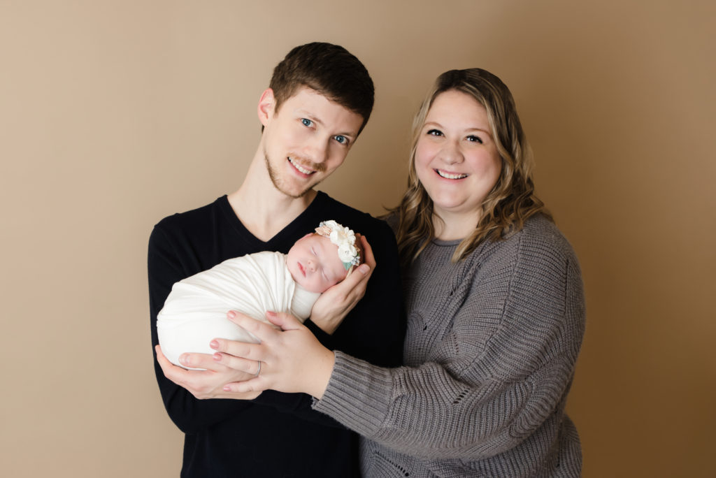 mom and dad holding newborn girl Pittsburgh Baby Photographer - Katie Louise Photography