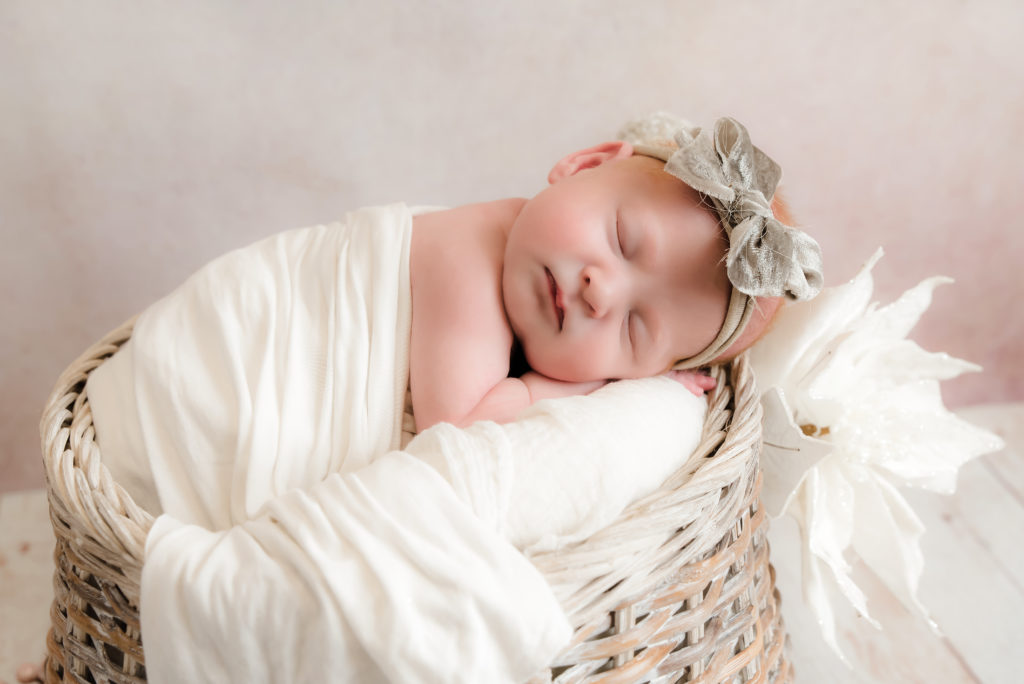 closeup of newborn girl sleeping on belly