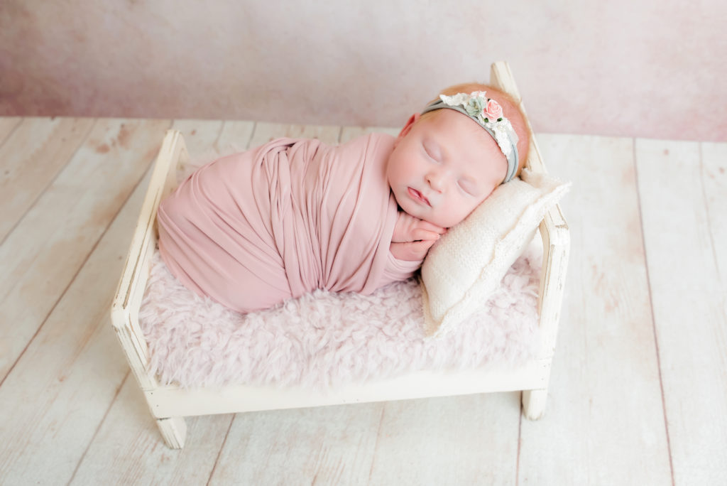 baby girl sleeping on side in tiny cream bed | Pittsburgh Baby Photographer
