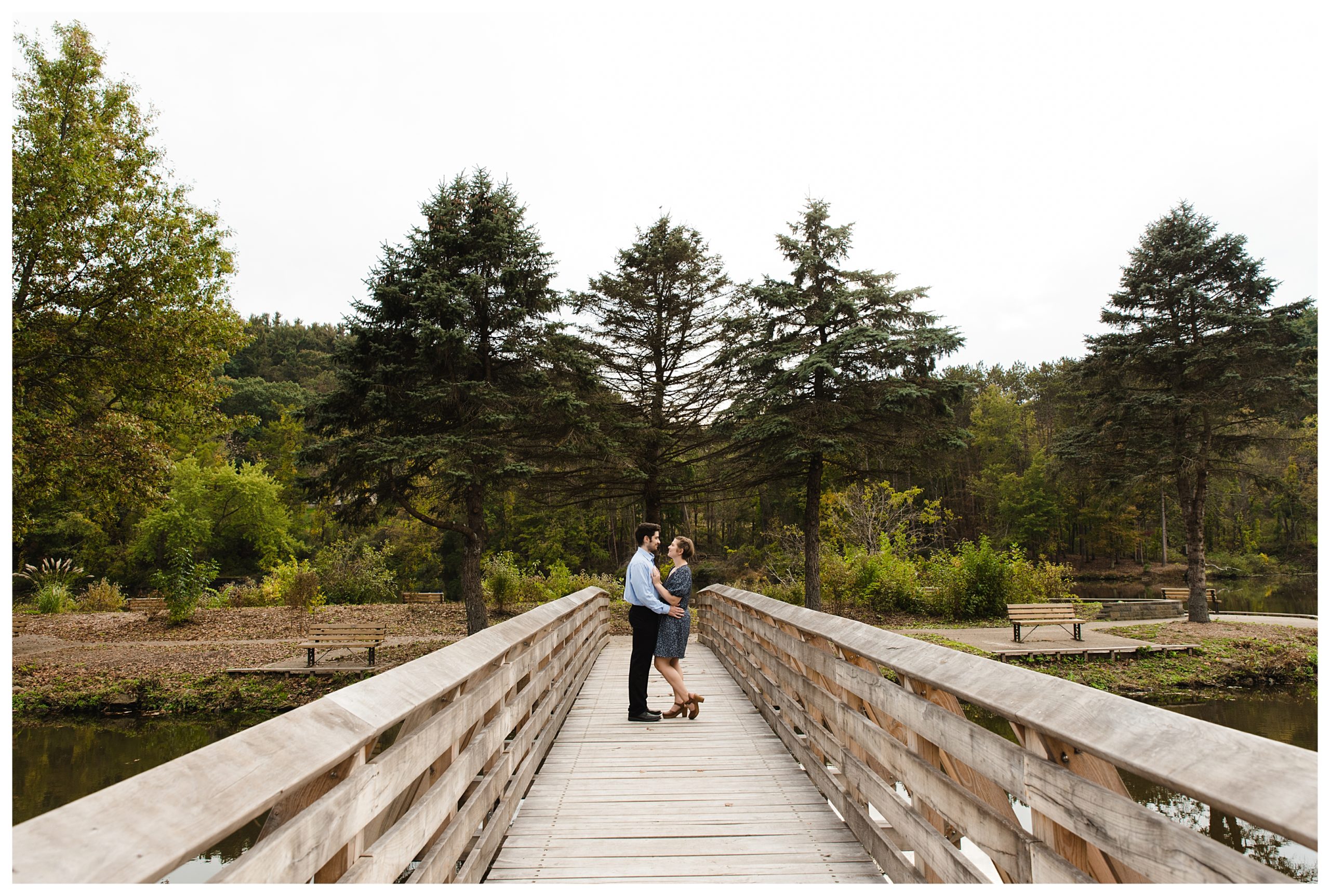 engaged couple kiss on bridge at marshall island in north park
