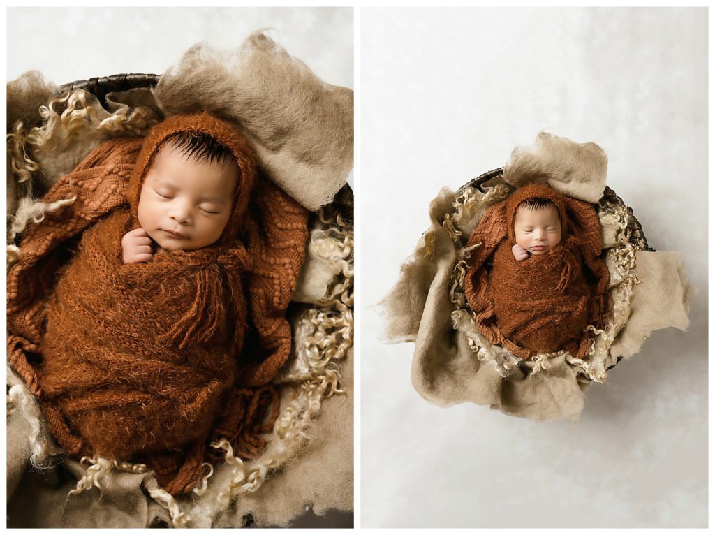 Newborn baby sleeping in round felted furs and wrapped in a rust fuzzy wrap.