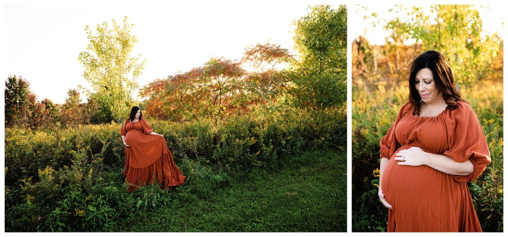 Pregnant mom wears rust dress while looking down at pregnant belly during maternity session at Fairview Park in Bridgeville, PA.