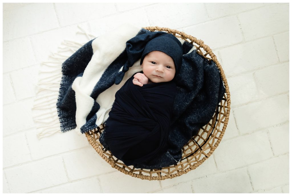 Baby Hudson Trubisky wrapped in navy blue lifestyle photo session Pittsburgh.