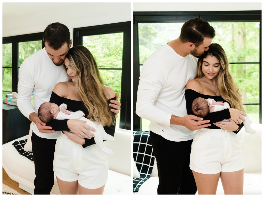 Mitch Trubisky kisses wife on temple while she holds baby Hudson during at-home lifestyle newborn session in Pittsburgh, PA.
