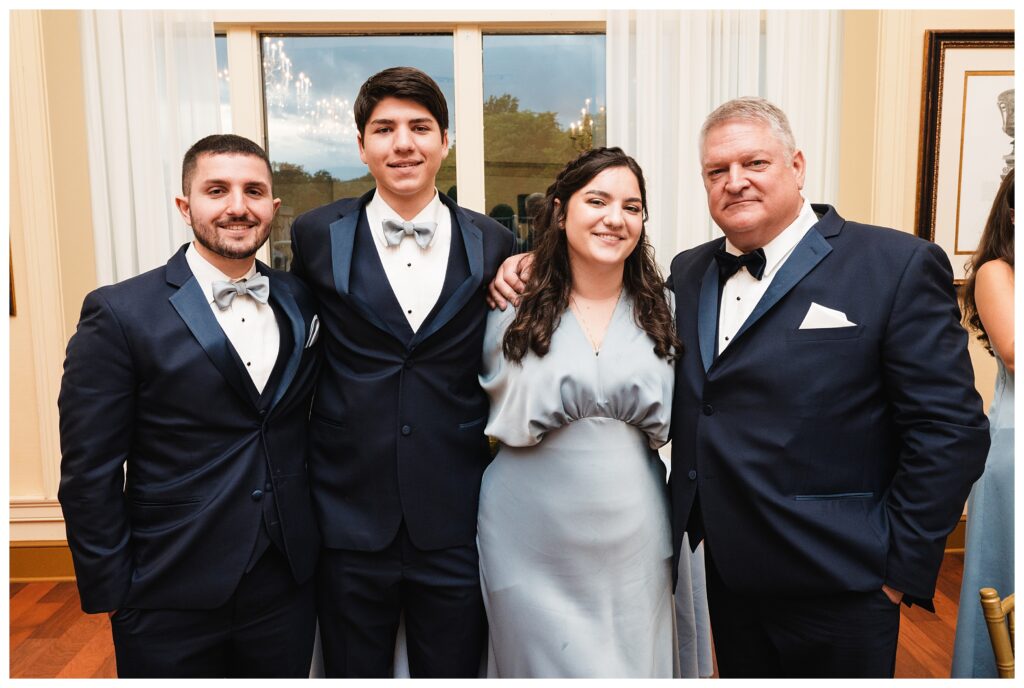groom poses at reception with his 4 kids at valley brook country club wedding
