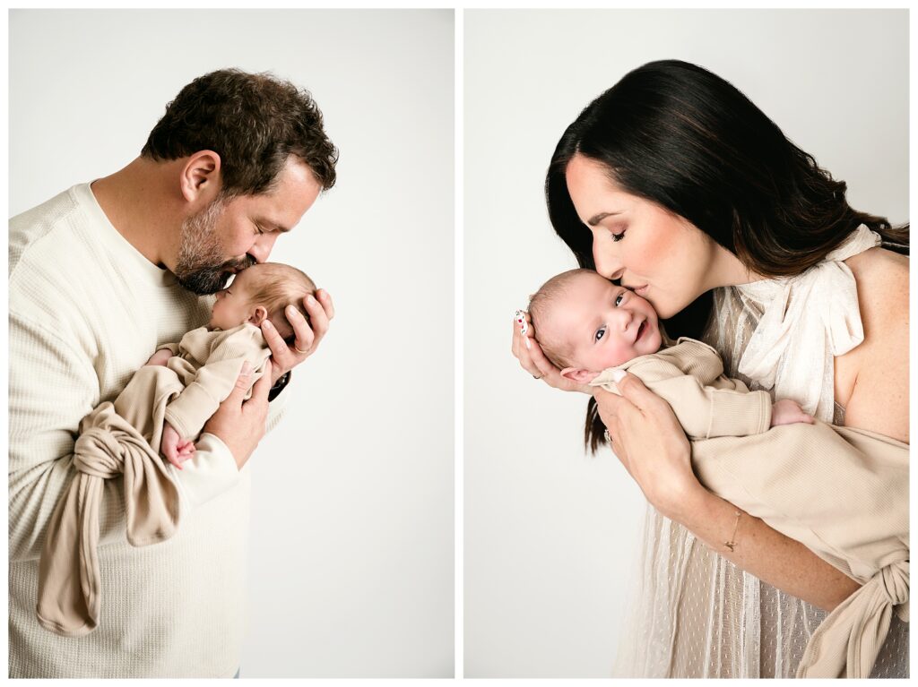 First image shows dad holding newborn son close and kissing his forehead. Second image shows mom bringing newborn boy close for a kiss and he has a huge smile on his face during this neutral studio newborn session.